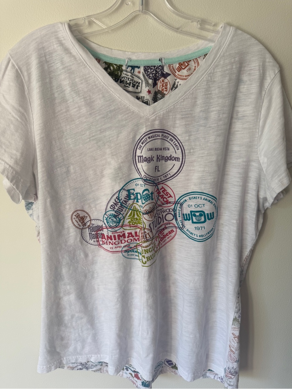 Disney White V‑Neck Tee with Multicolor Park Stamp Graphics